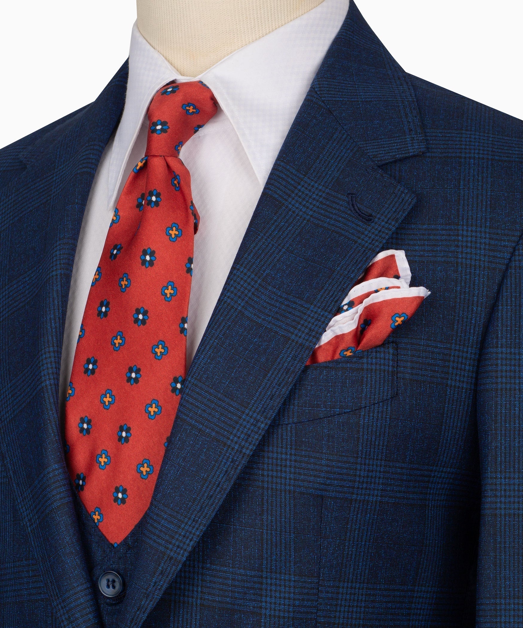 Navy plaid lapel with red patterned tie and folded pocket square