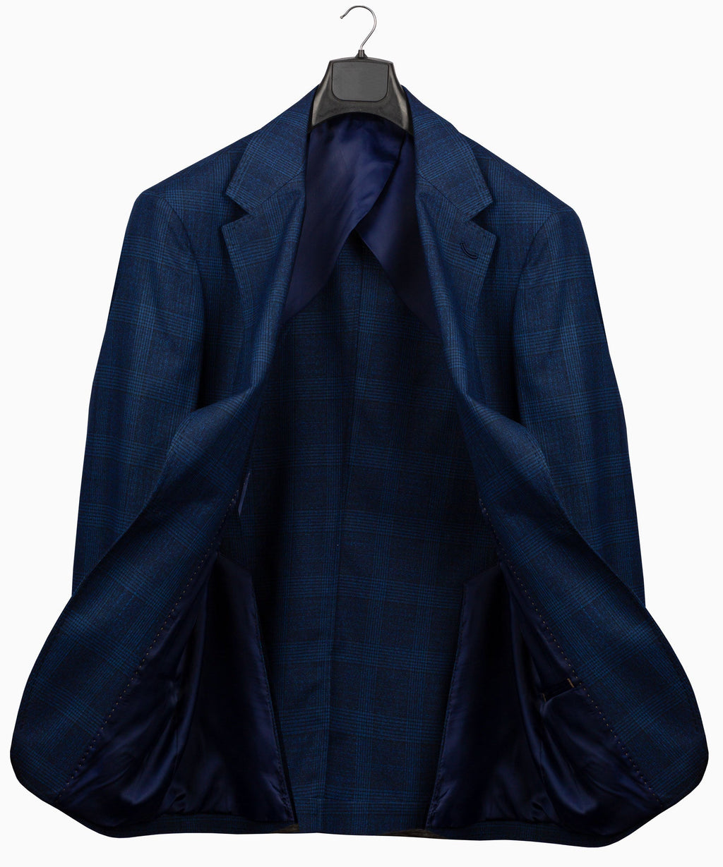 Navy plaid suit jacket back view with center seam and vented hem