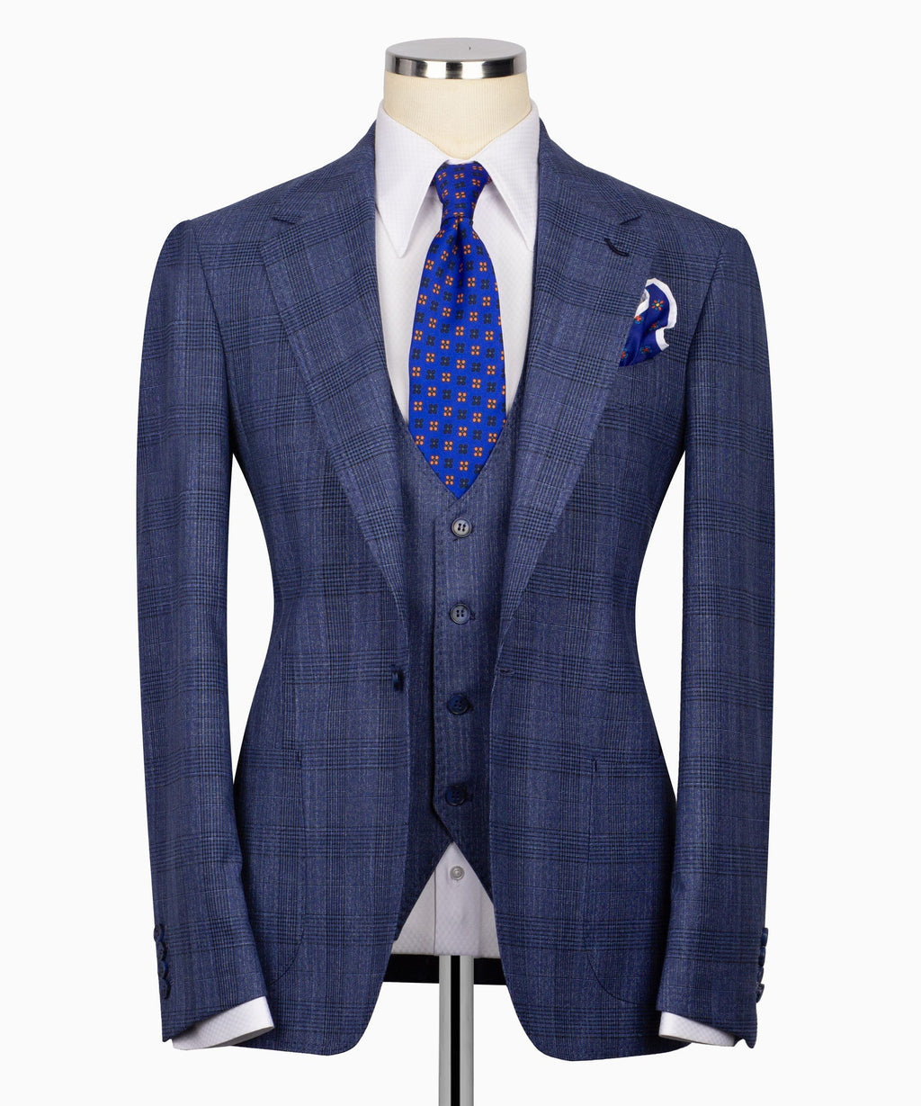 Blue plaid three-piece suit jacket with notched lapels, vest, patterned tie, and pocket square