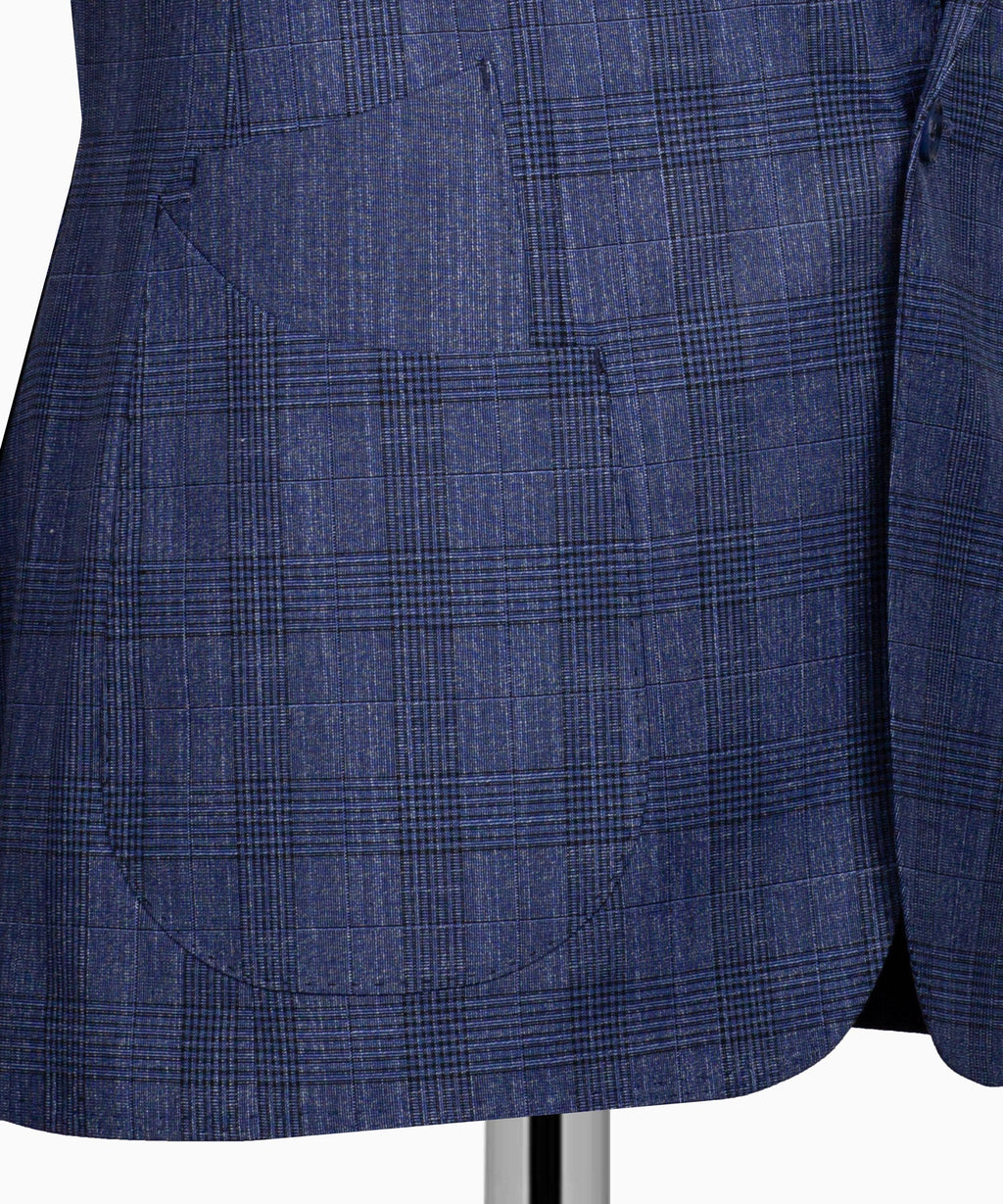Close-up view of blue plaid suit fabric on the three-piece set