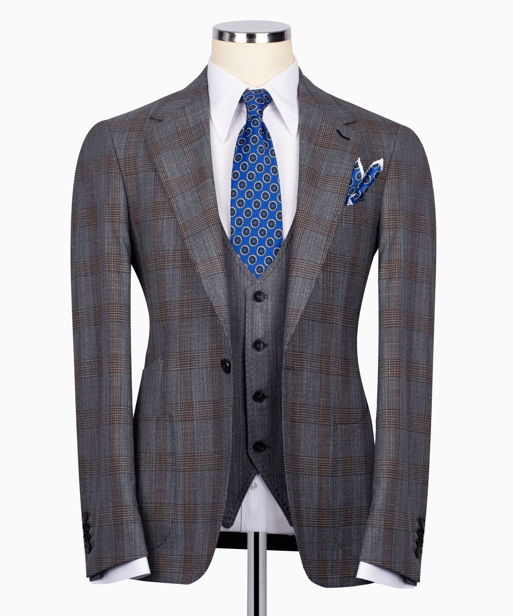 Grey plaid men’s suit jacket with black waistcoat, blue patterned tie and pocket square
