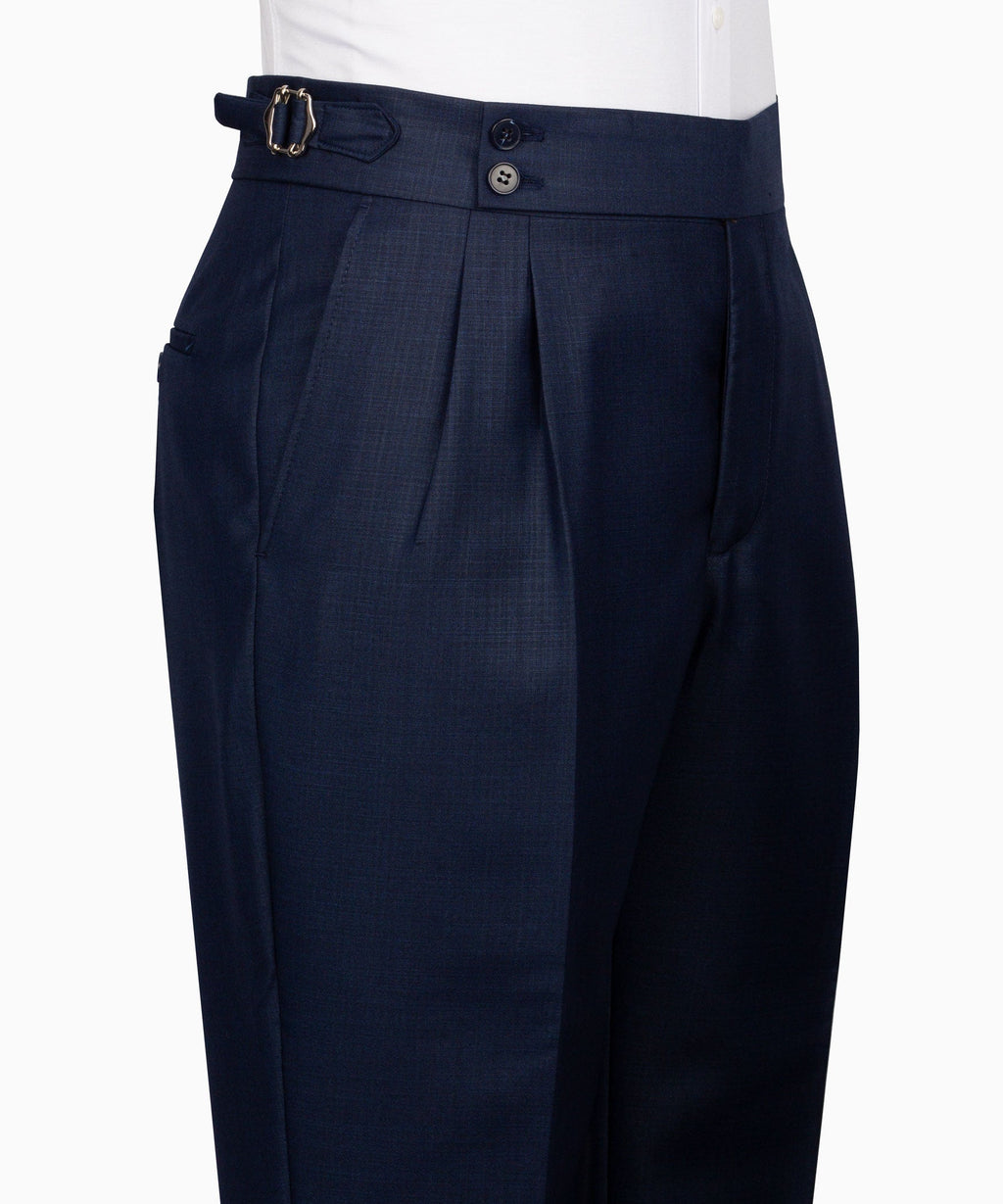 Navy plaid dress trousers with pleats, belt loops, and button closure