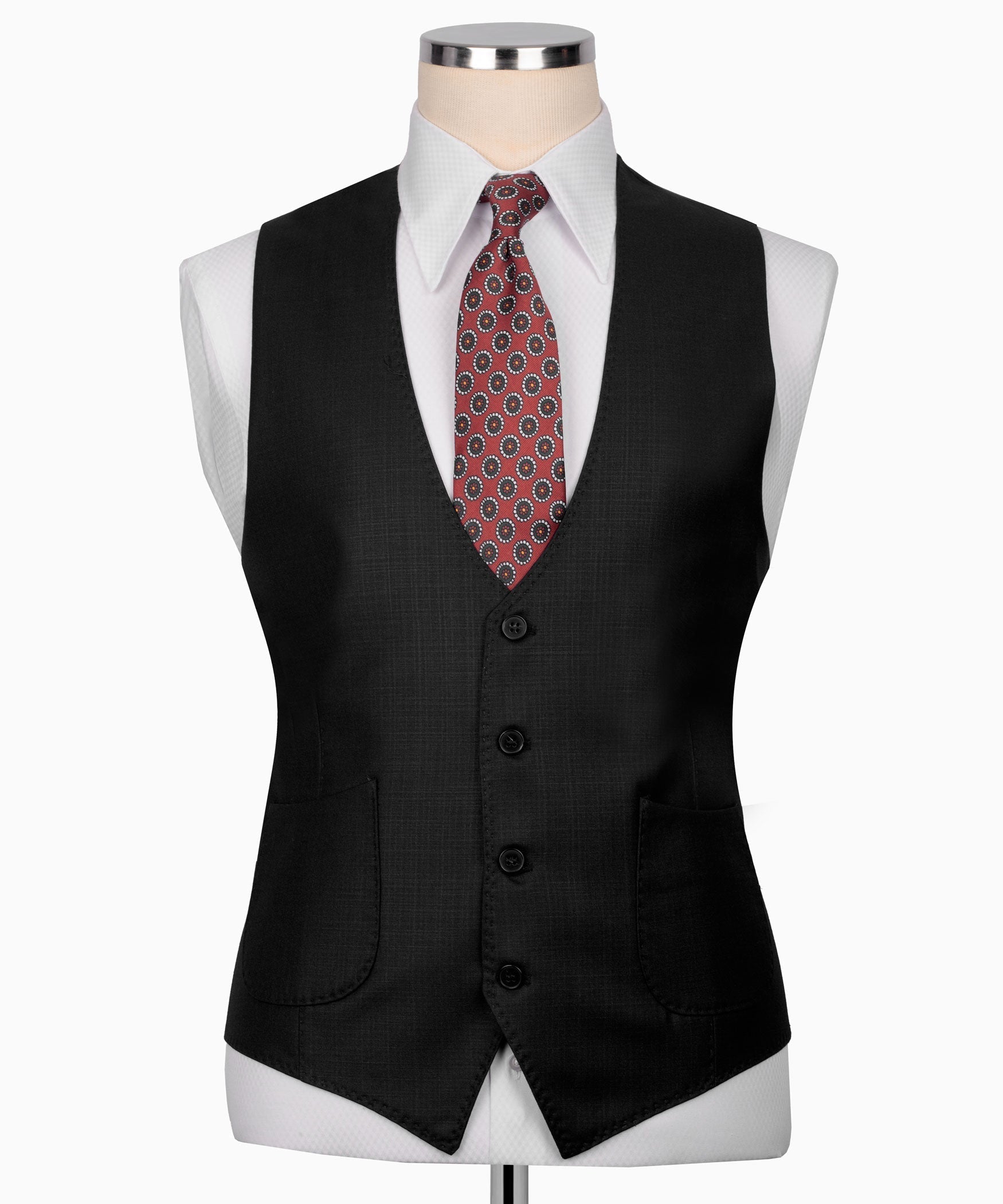 Black suit vest with button front, flap pockets, and patterned necktie on mannequin.