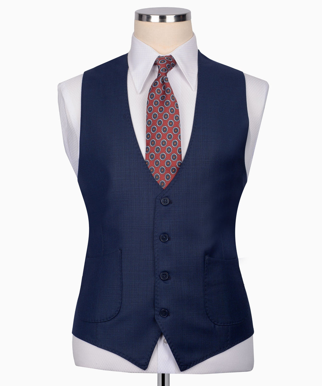 Navy plaid suit vest with button front and welt pockets, worn with patterned tie