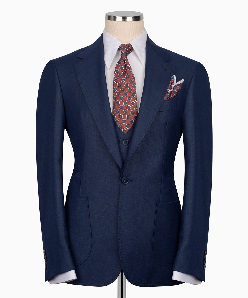 Navy plaid three-piece suit front view with jacket, vest, patterned tie, pocket square