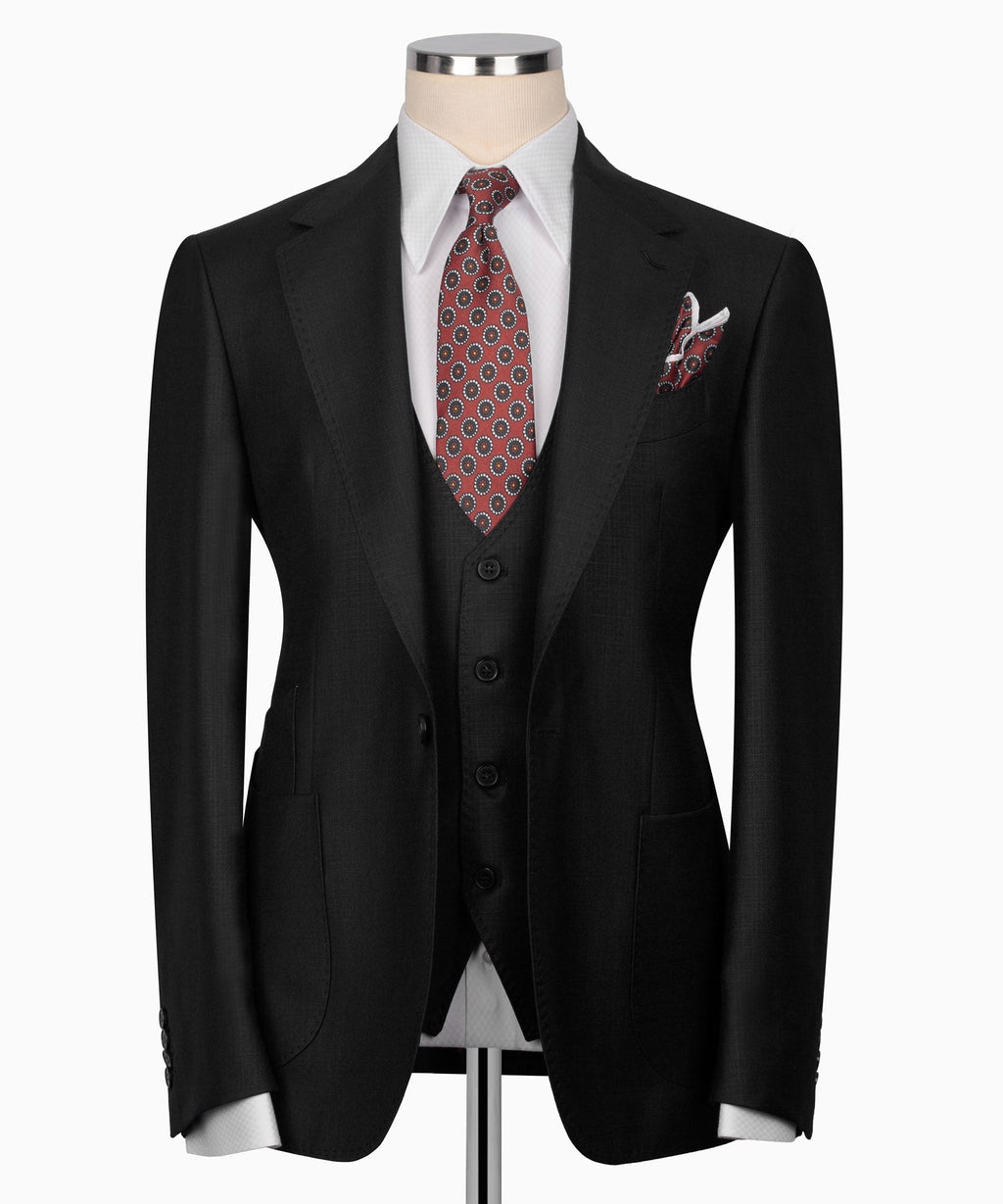 Black three-piece suit jacket with matching vest, patterned tie, and pocket square.