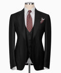 Black three-piece suit jacket with matching vest, patterned tie, and pocket square.