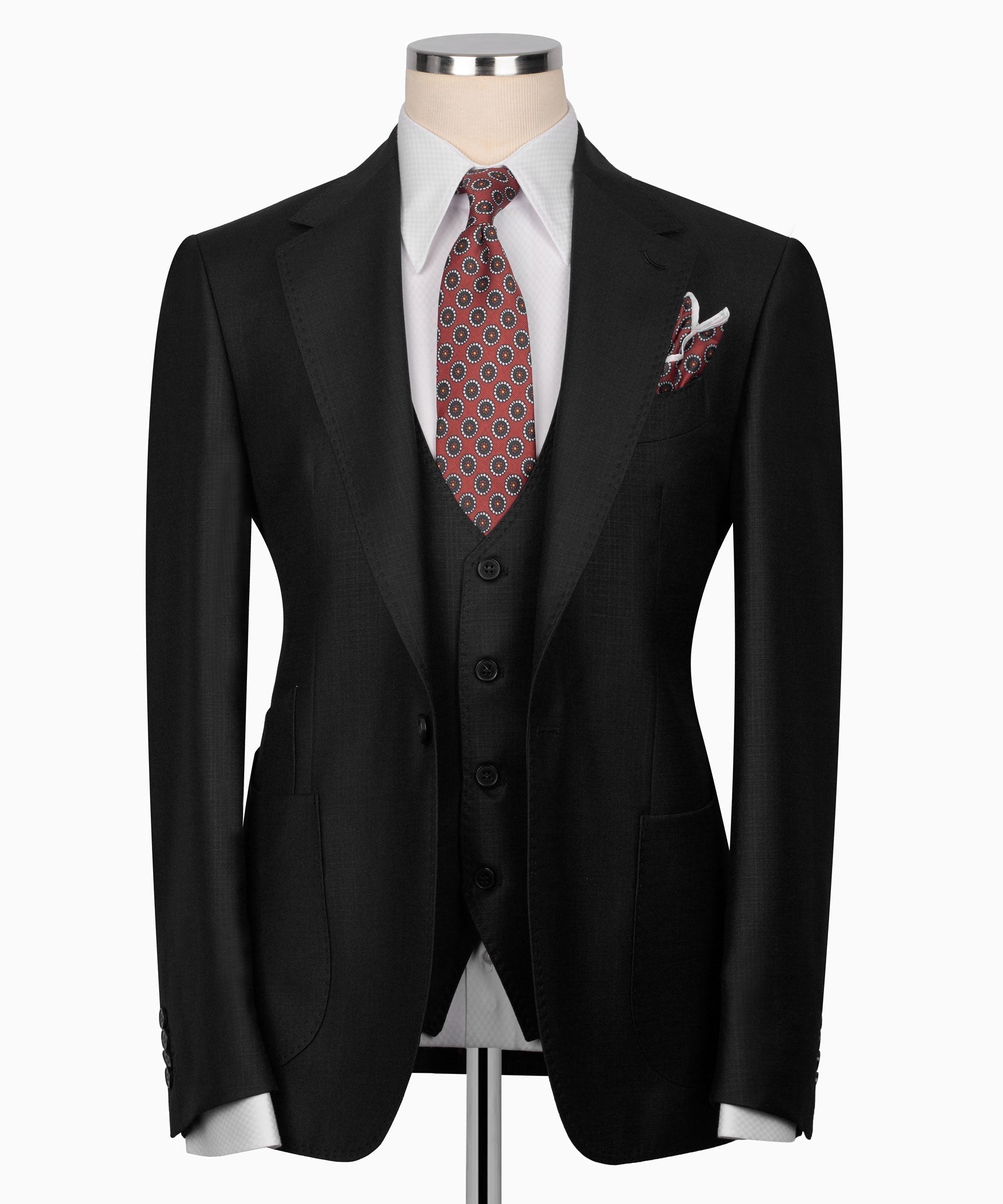 Black three-piece suit jacket with matching vest, patterned tie, and pocket square.