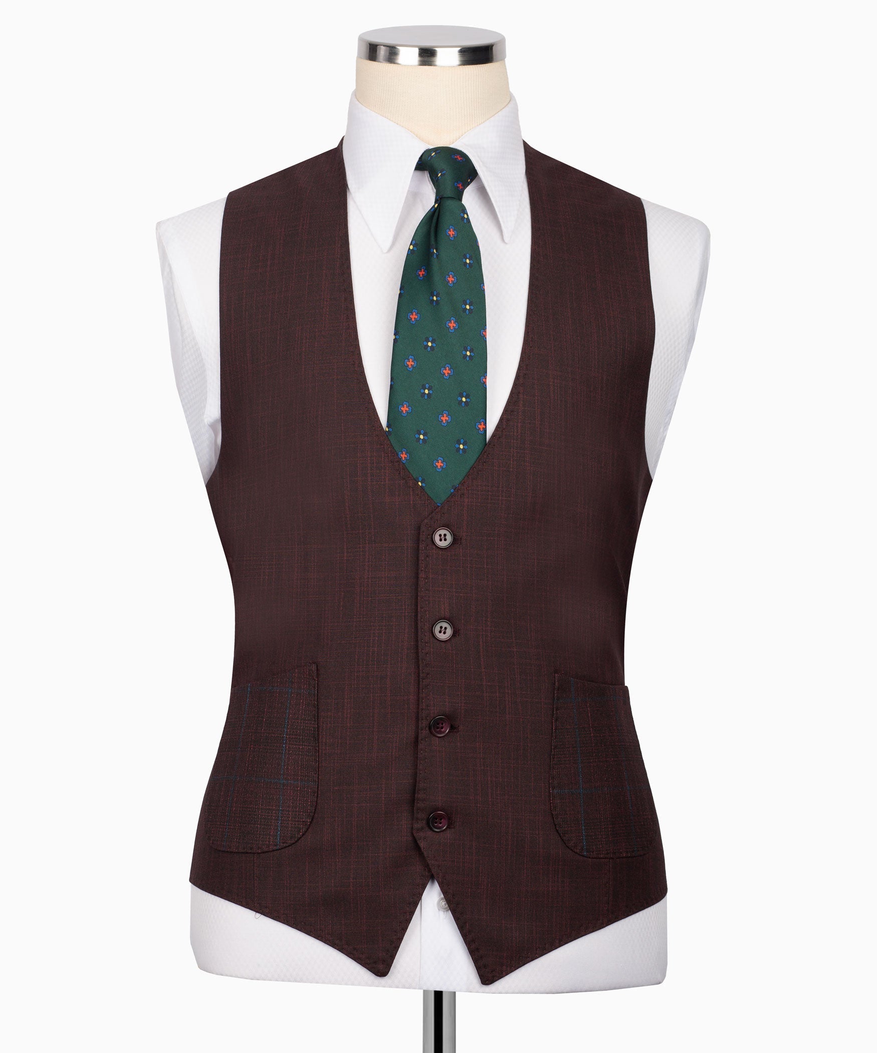 Plaid three-piece suit vest styling with green patterned tie and matching pocket details