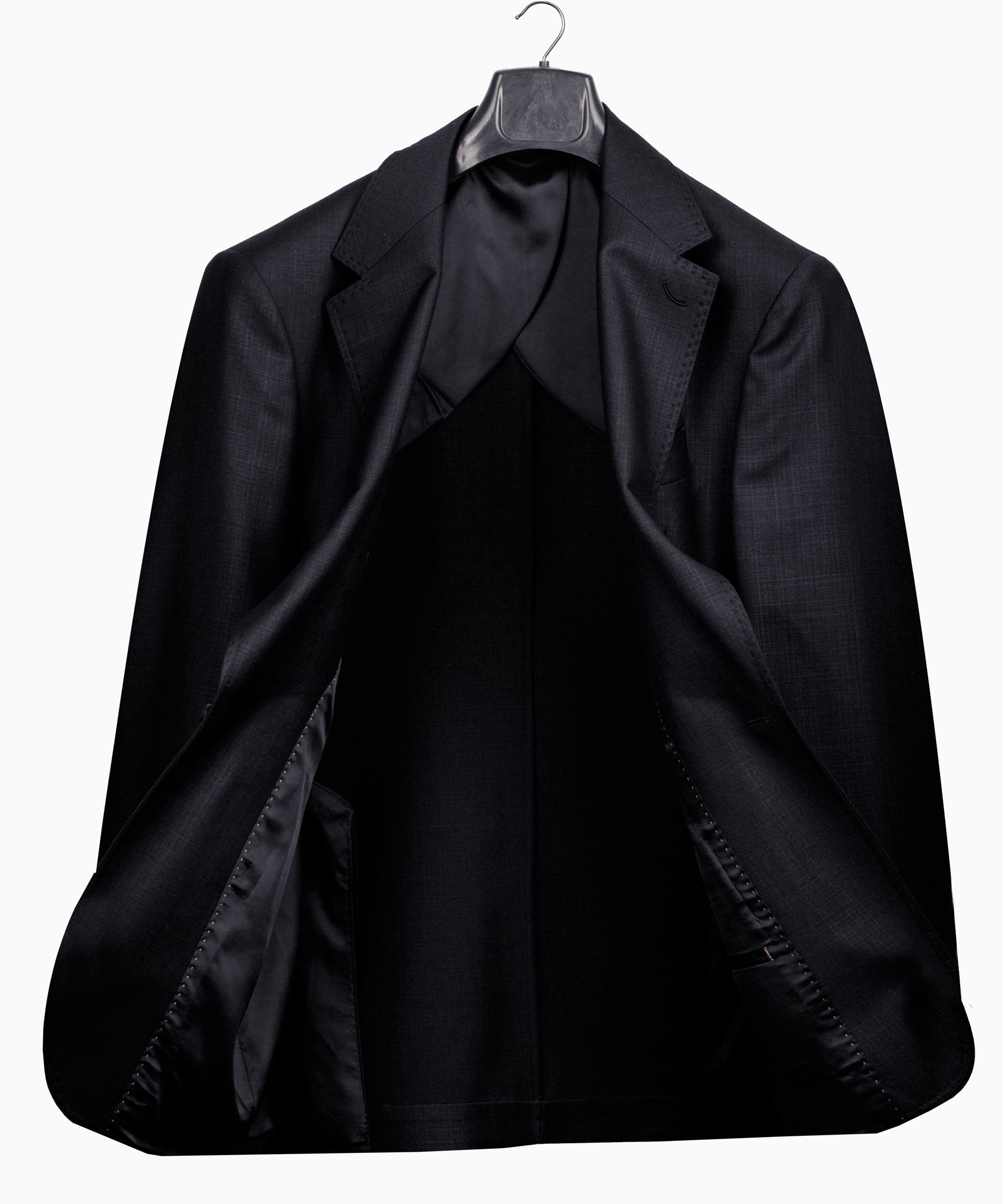 Black suit jacket back view with vented hem and hanging loop.