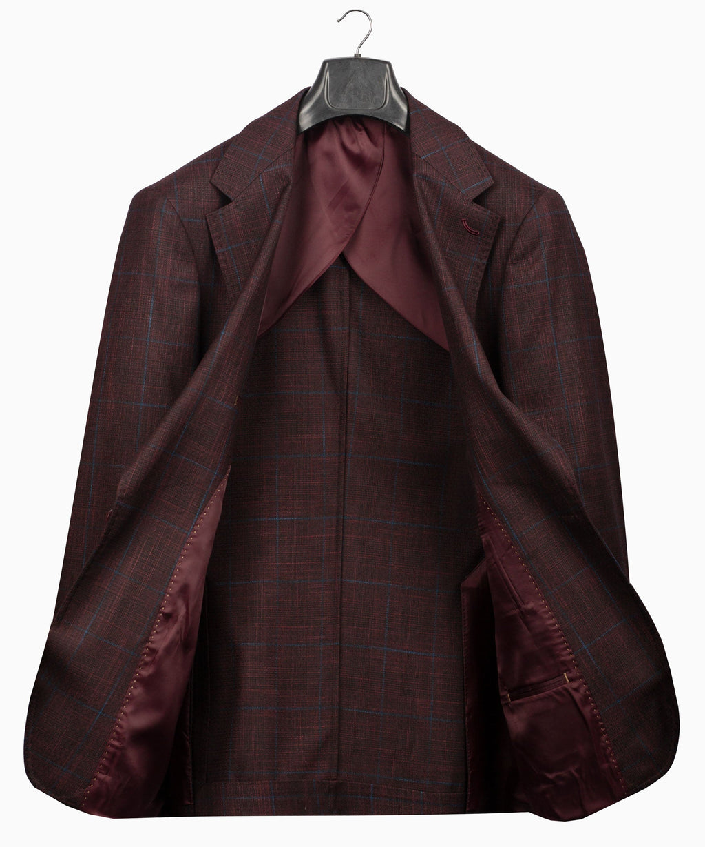 Plaid men’s suit jacket and vest showing interior lining on hanging set
