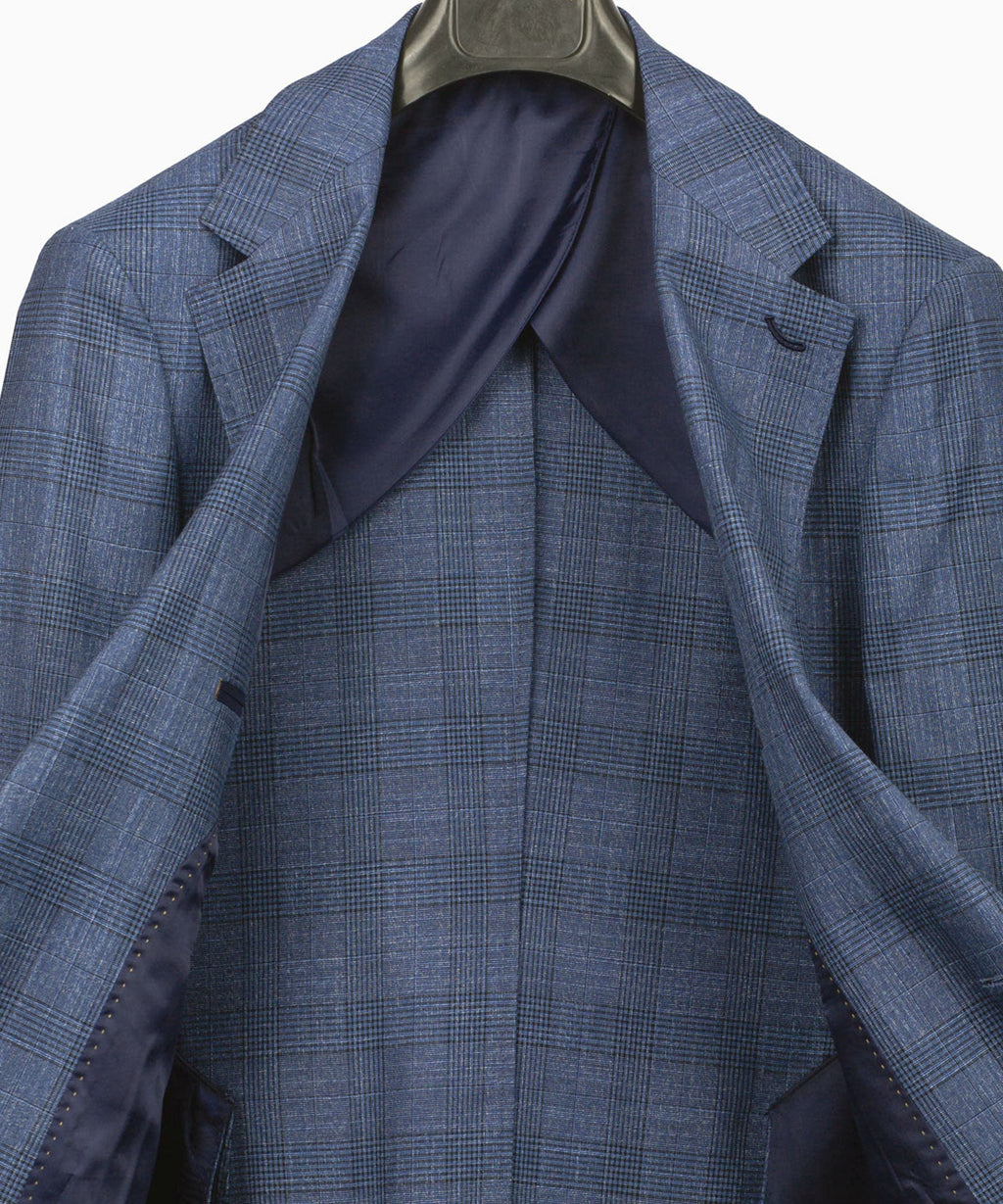 Blue plaid suit jacket interior with wide lapels and tailored seam panels
