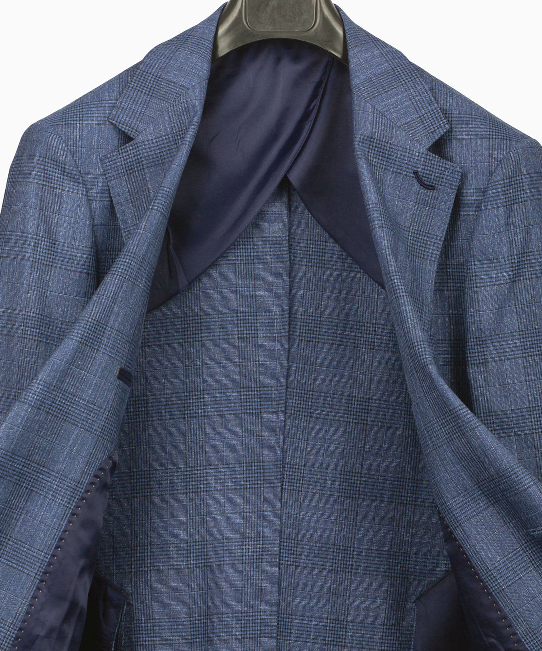 Blue plaid suit jacket interior with wide lapels and tailored seam panels
