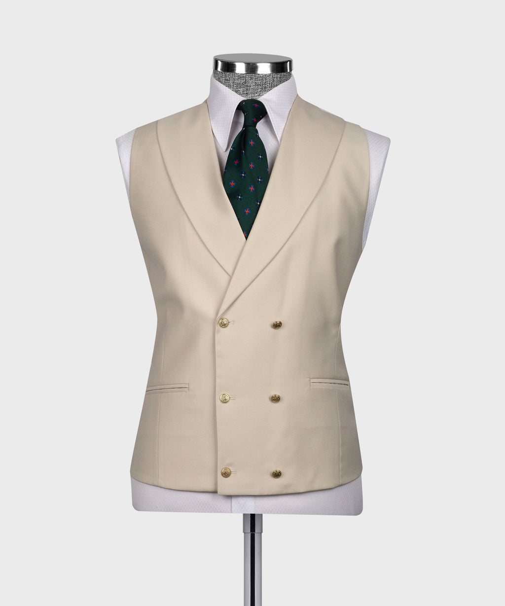 Beige waistcoat with double-breasted front, green patterned tie, and pocket square