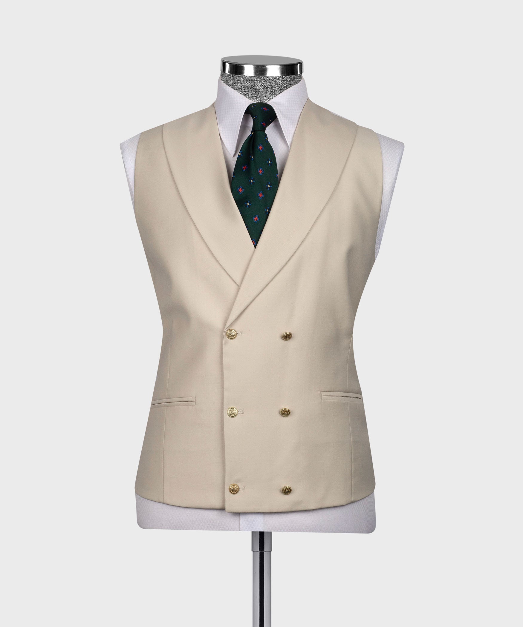 Beige waistcoat with double-breasted front, green patterned tie, and pocket square