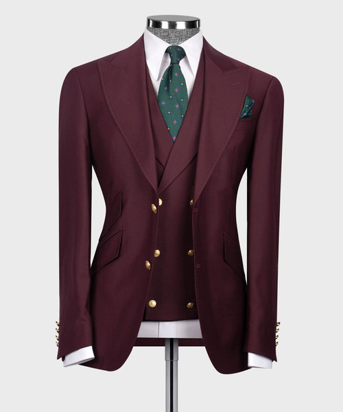 Burgundy classic three-piece suit: blazer, vest, green patterned tie, pocket square.