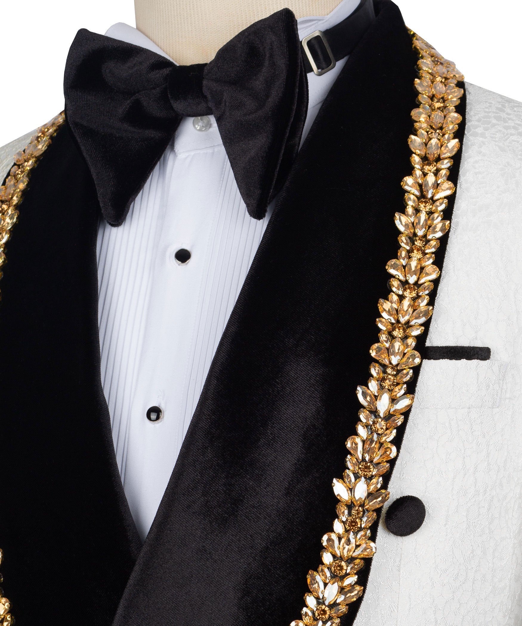 Close view: black bow tie, white shirtfront, and gold leaf-embossed trim on lapel