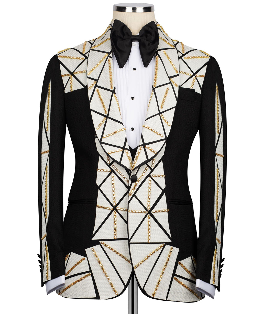Tuxedo suit with black satin bow tie, white vest with black buttons, gold chain details