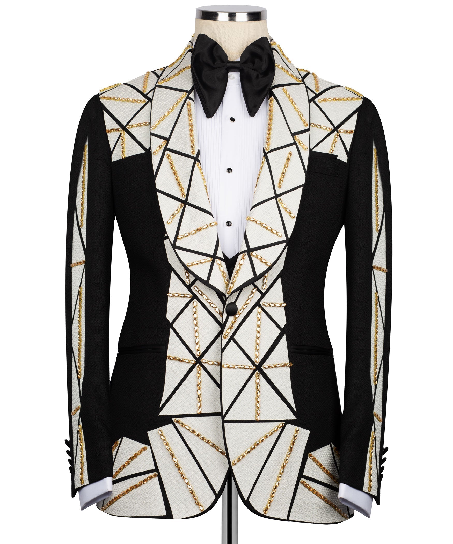 Tuxedo suit with black satin bow tie, white vest with black buttons, gold chain details