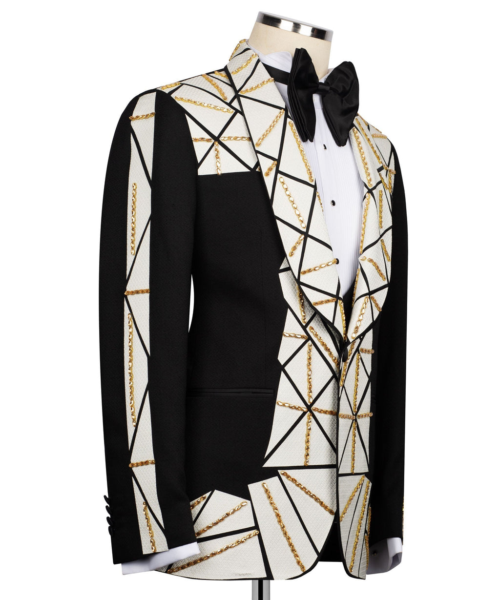 Patchwork tuxedo suit side: black blazer with white geometric panels and gold chain trim