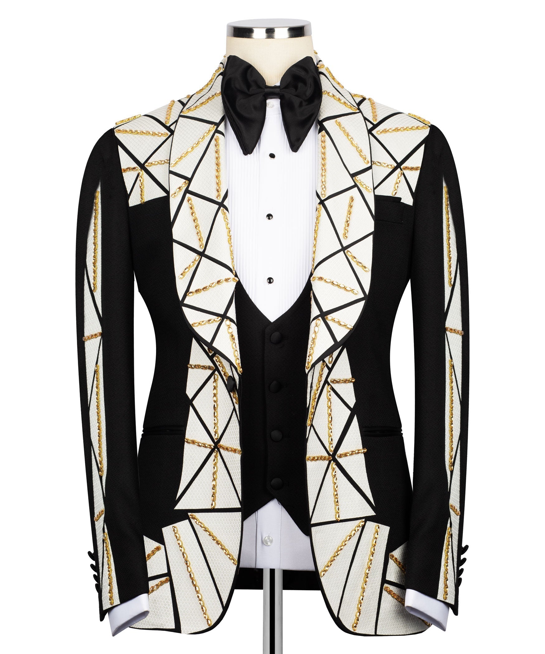 Patchwork tuxedo jacket with black bow, white patterned lapels, gold chain embroidery