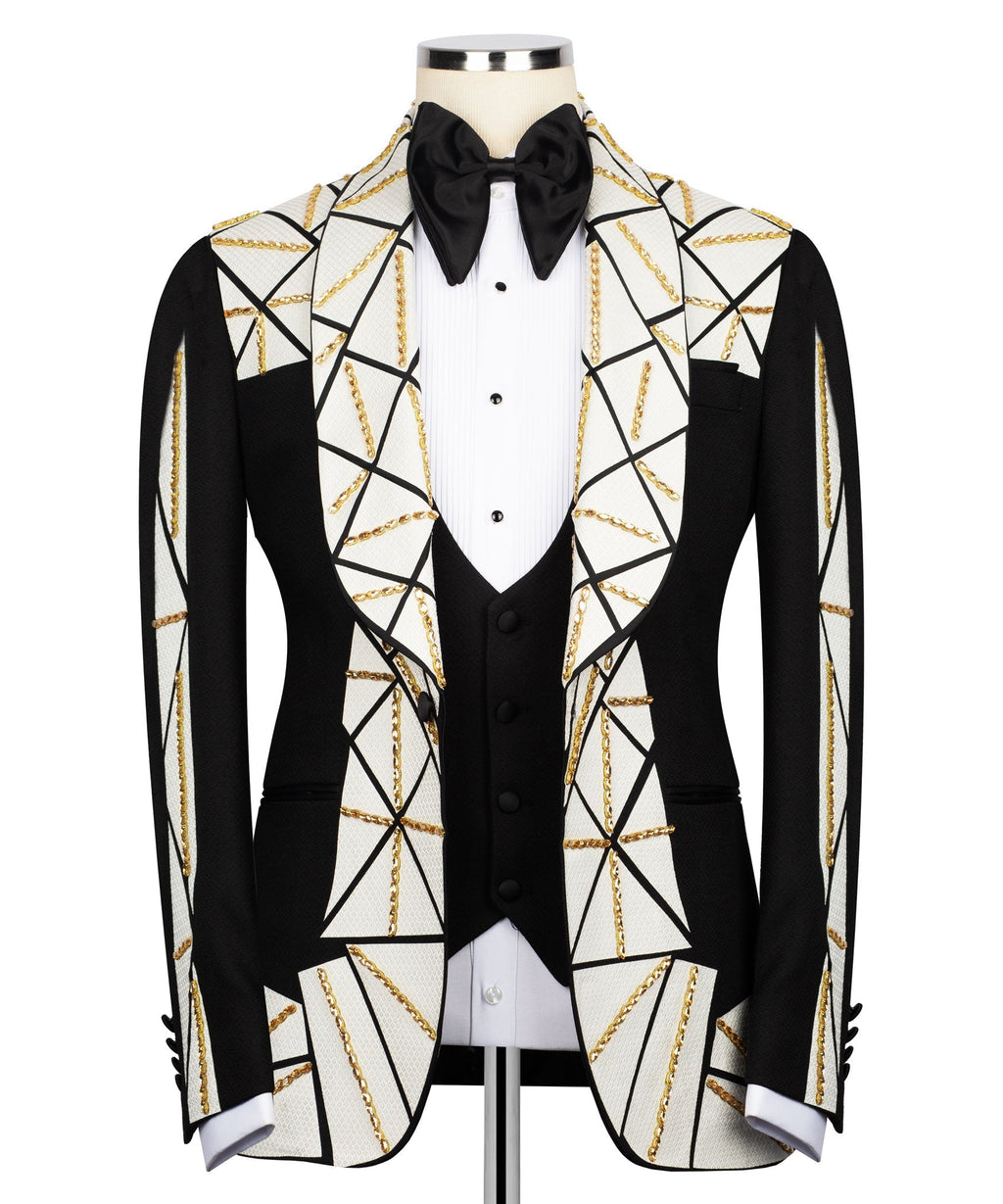 Patchwork tuxedo suit: black jacket, white geometric panels, gold chain embroidery, bow tie