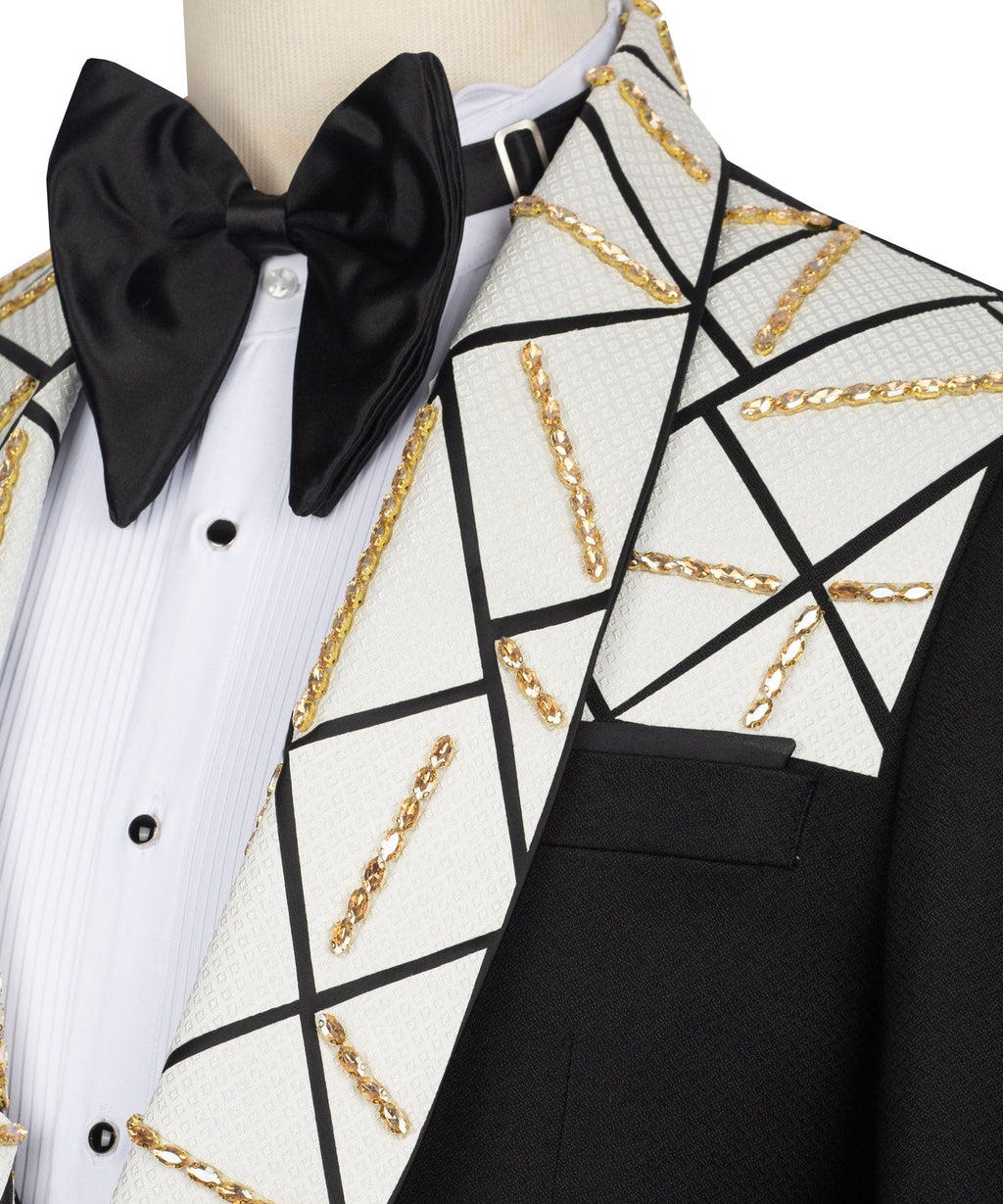 Close-up bow tie and lapel: black bow, white vest panel, gold chain embroidery