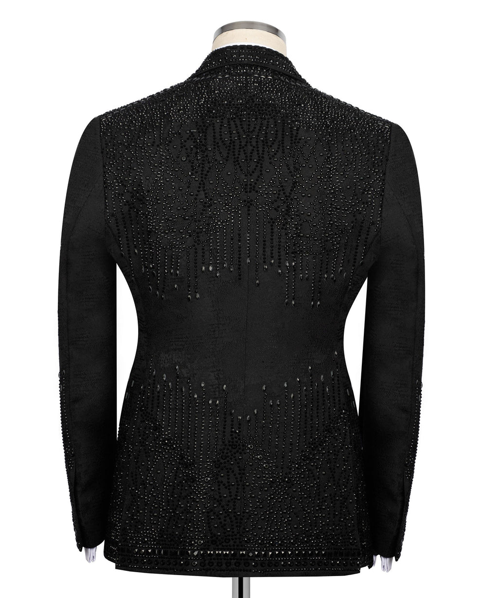 Back view of black studded tuxedo jacket with vertical embellishment