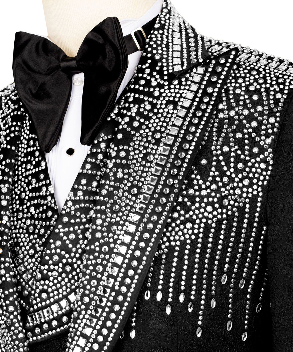 Close-up: black tuxedo bow tie and stone-embossed lapel with patterned trim