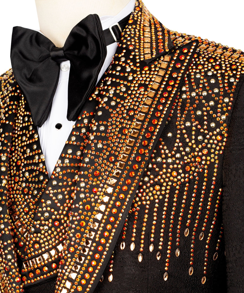 Close-up of black tuxedo lapel with gold and red stone embroidery and bow tie