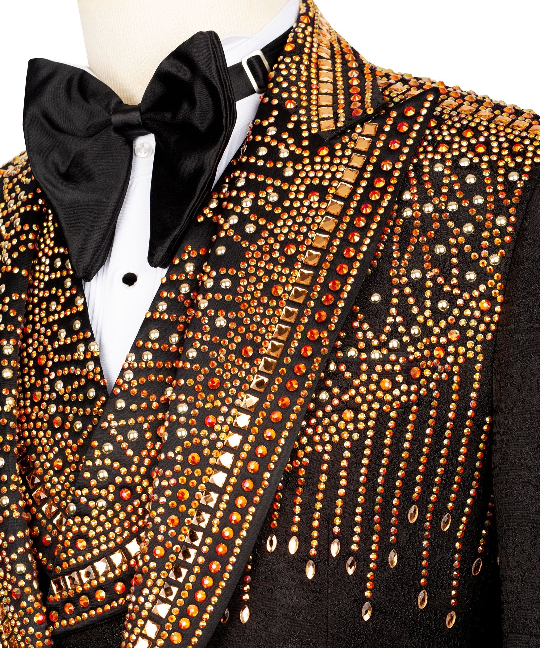 Close-up of black tuxedo lapel with gold and red stone embroidery and bow tie