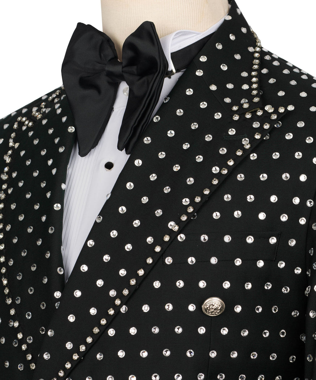 Close-up: black tuxedo jacket with silver stone buttons and satin bow tie