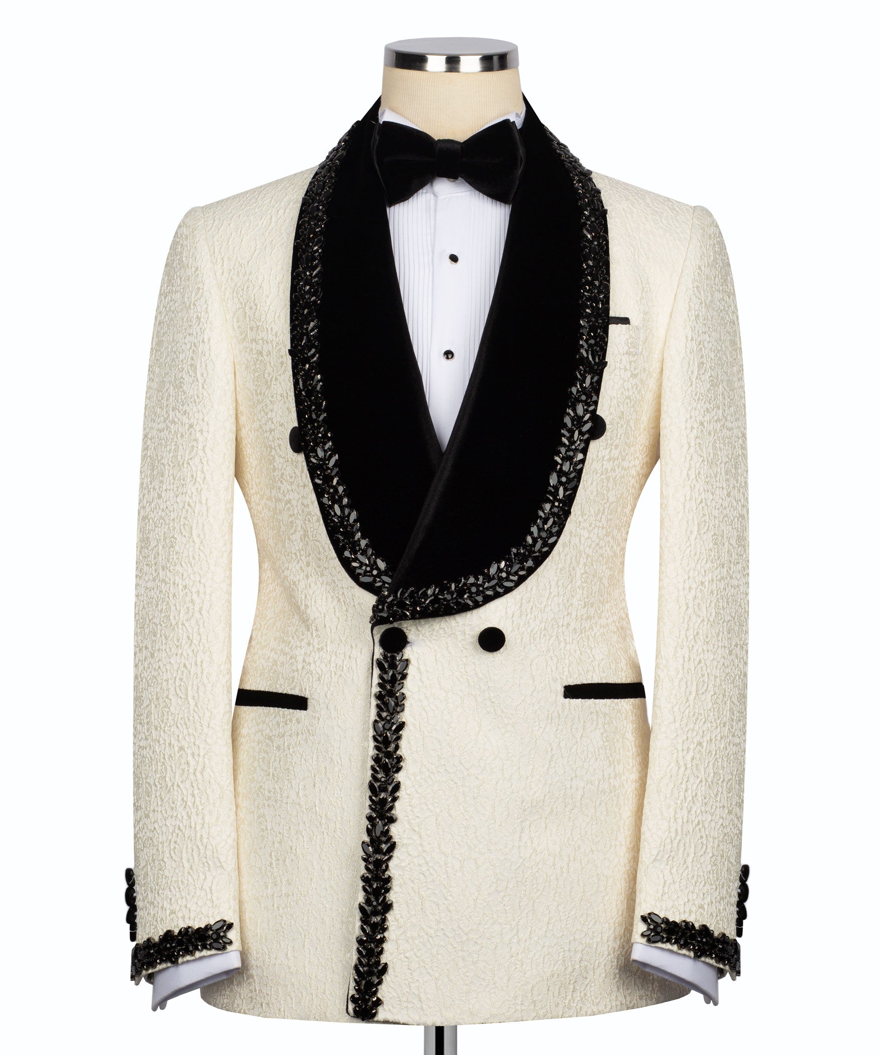Cream tuxedo jacket with black satin lapels, bow tie, and stone-embroidered trim