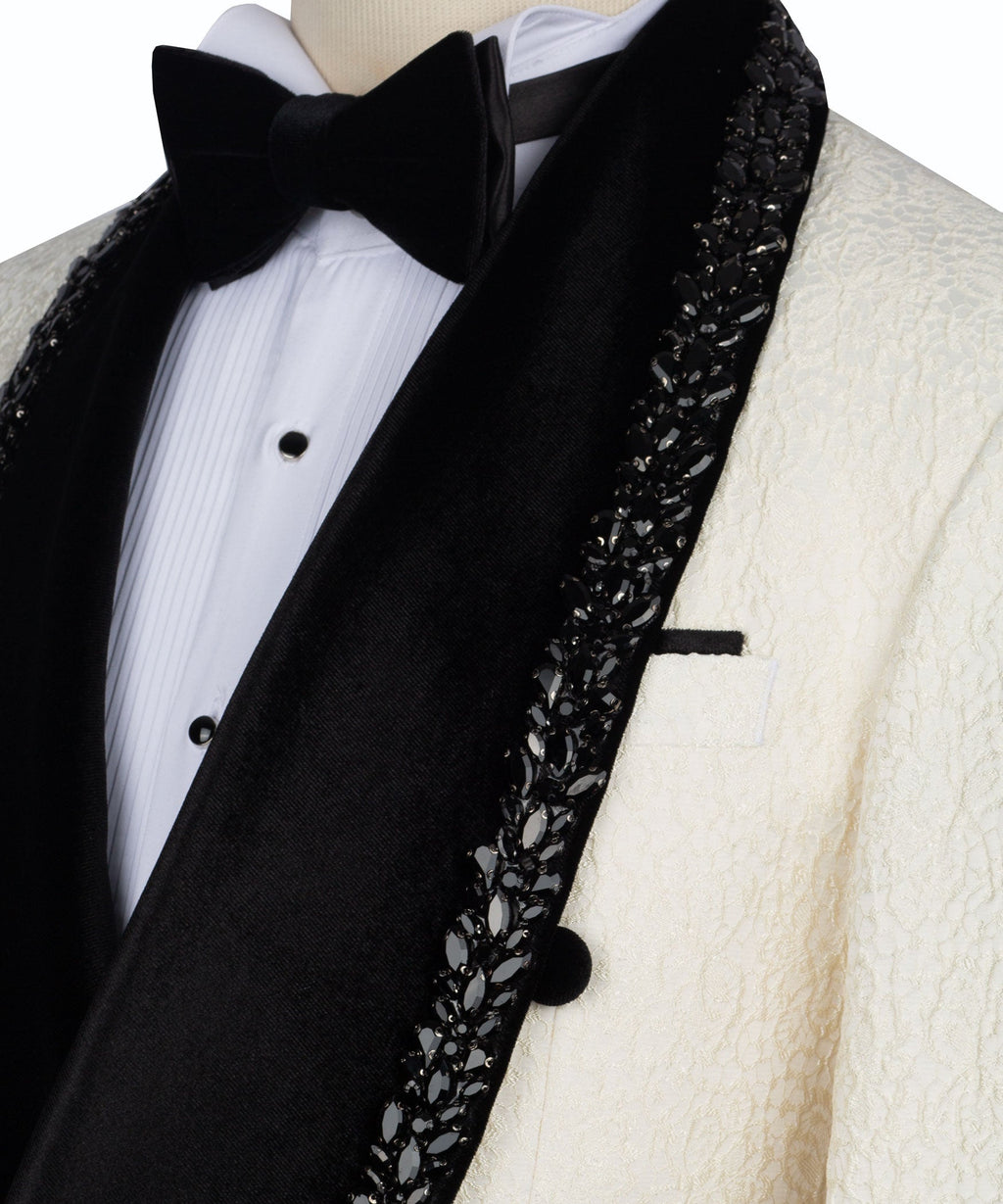 Close-up of black stone-embroidered lapel trim with bow tie and white dress shirt
