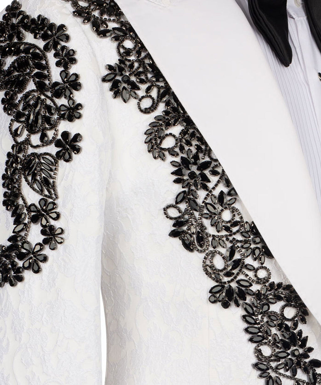 Close-up: white tuxedo jacket with black stone-embellished diagonal floral trim