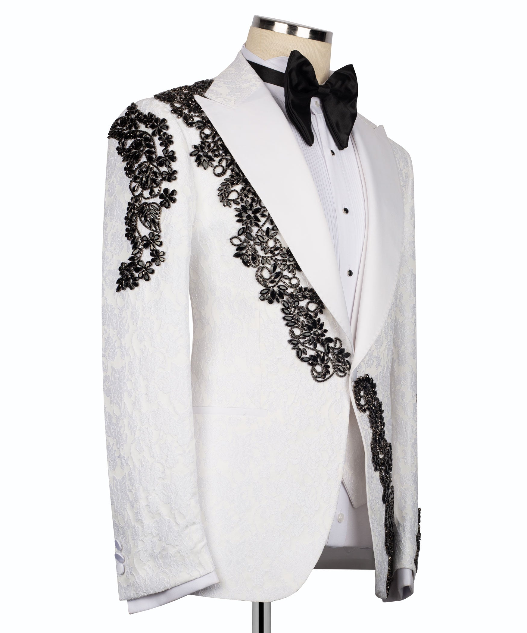 White tuxedo jacket front with black stone-embellished floral trim and black bow tie