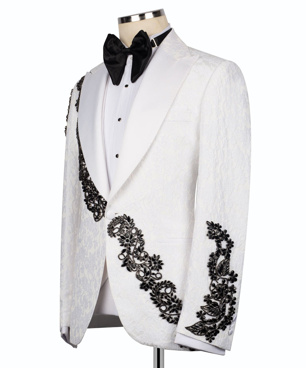 White tuxedo jacket with black stone-embellished diagonal trim and black bow tie