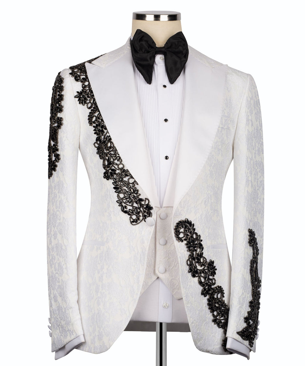 White tuxedo jacket, black stone-embellished lapel and cuffs, with black bow tie