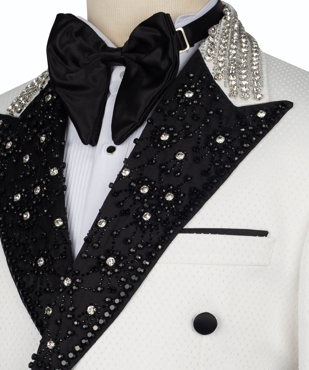 Close-up: black sequined shawl collar with rhinestone-like embellishments and satin bow