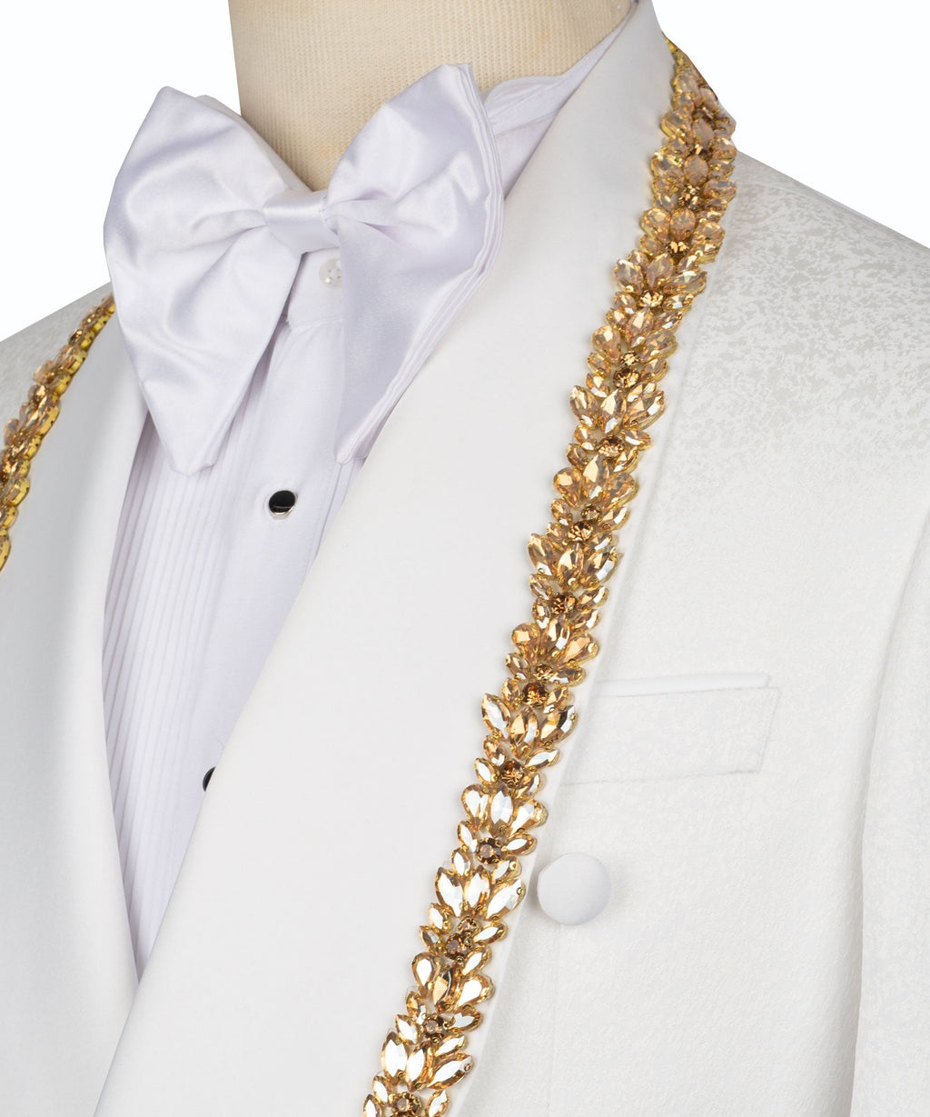 Close-up: white bow shirt and gold embellished chain embroidery on tuxedo jacket