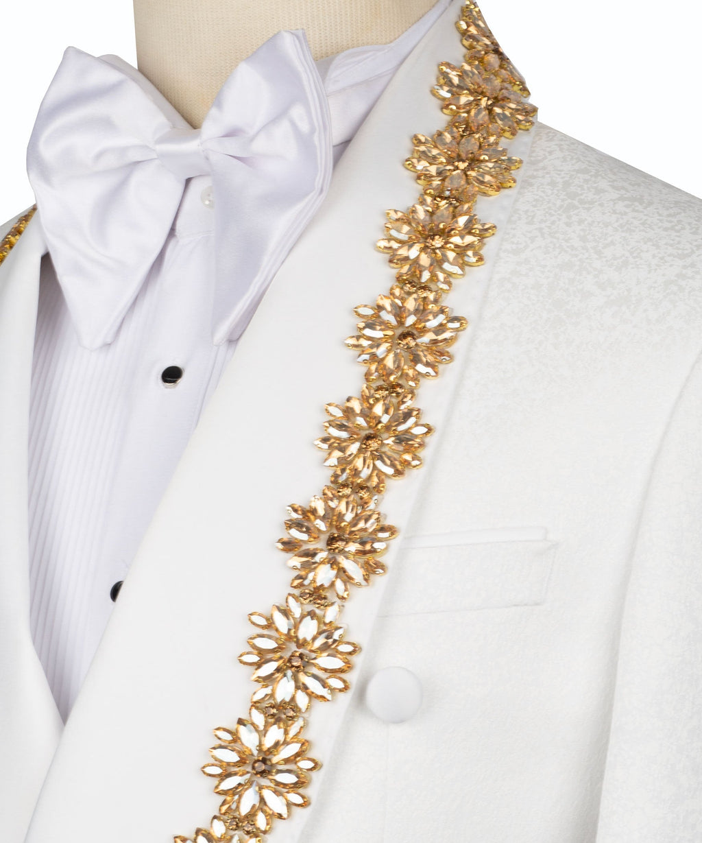 Close-up: white bow tie and gold floral chain embellishment on tuxedo