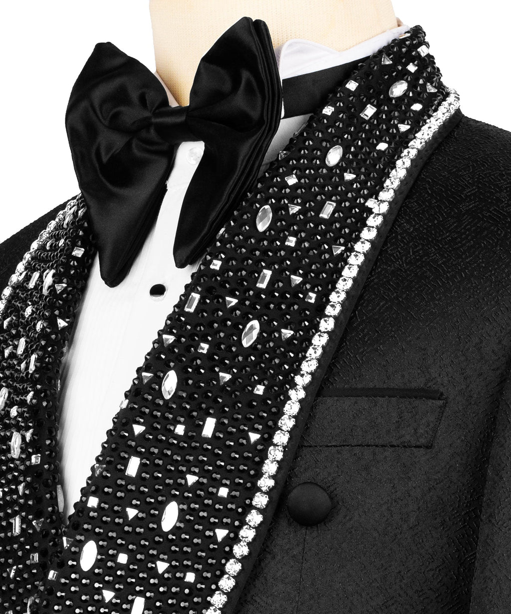 Close-up: black bow tie, white shirt, crystal-embellished lapel with studs