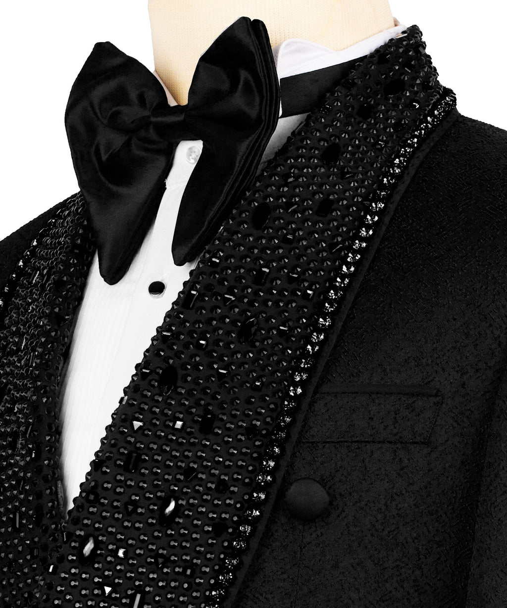 Close-up of black satin bow tie, white shirt, and stone-embroidered tux lapel
