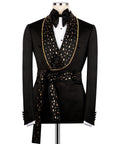 Men's black tuxedo jacket with gold stone embroidery, bow tie, and belted waist detail