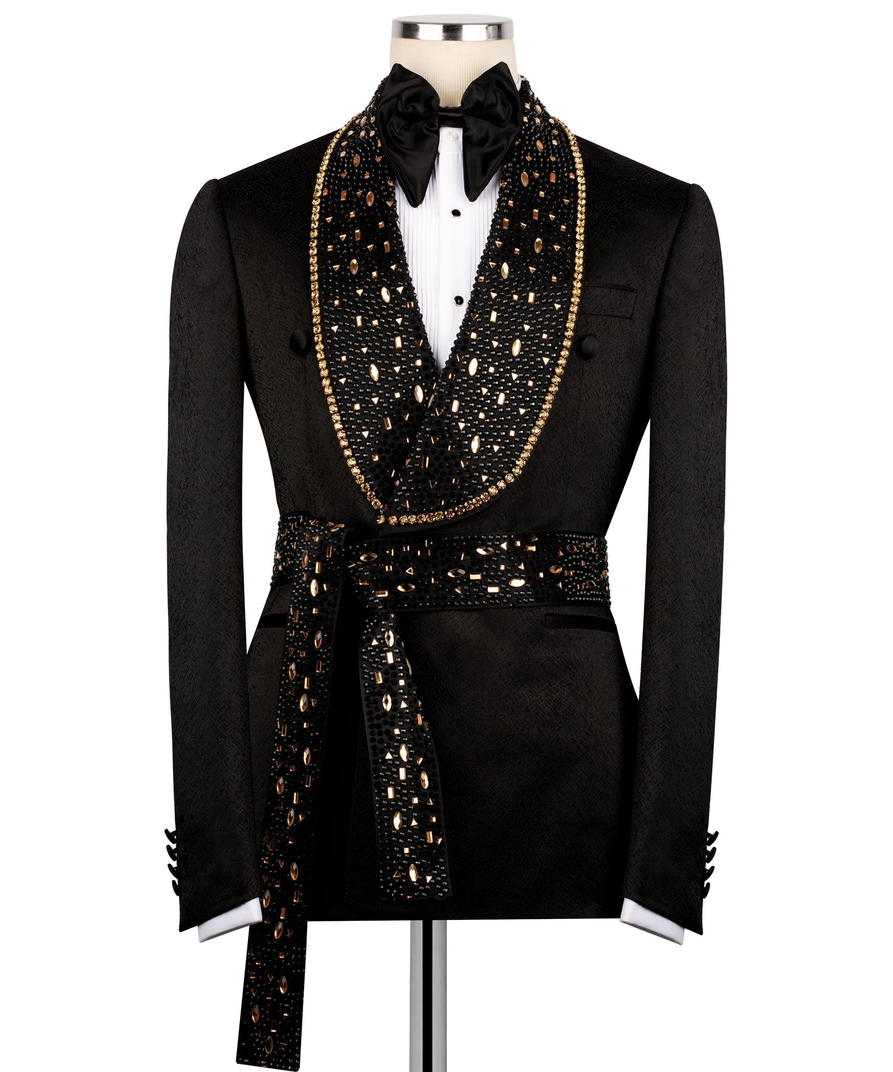 Men's black tuxedo jacket with gold stone embroidery, bow tie, and belted waist detail