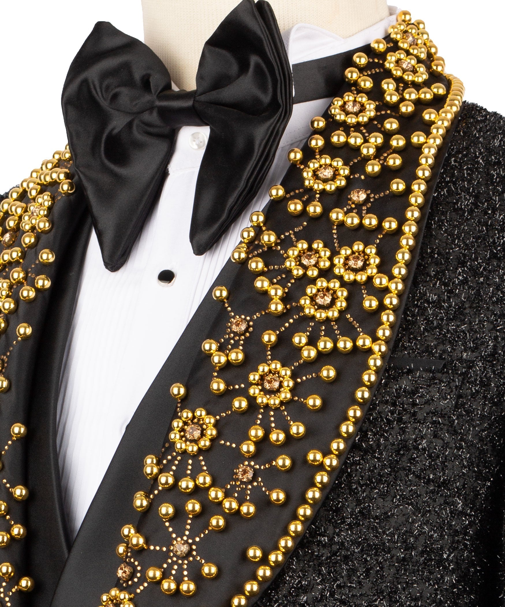 Close-up: black bow tie and gold bead embroidery on tuxedo lapel over white shirt