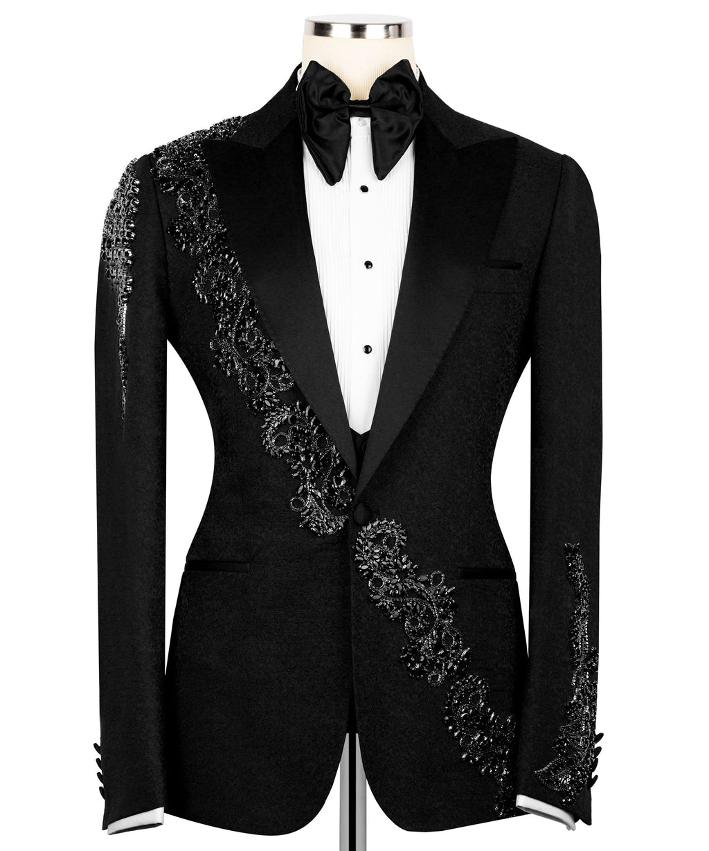 Black tuxedo jacket with stone-embroidered waist detail and jeweled lapel