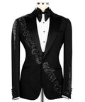 Black tuxedo jacket with stone-embroidered waist detail and jeweled lapel