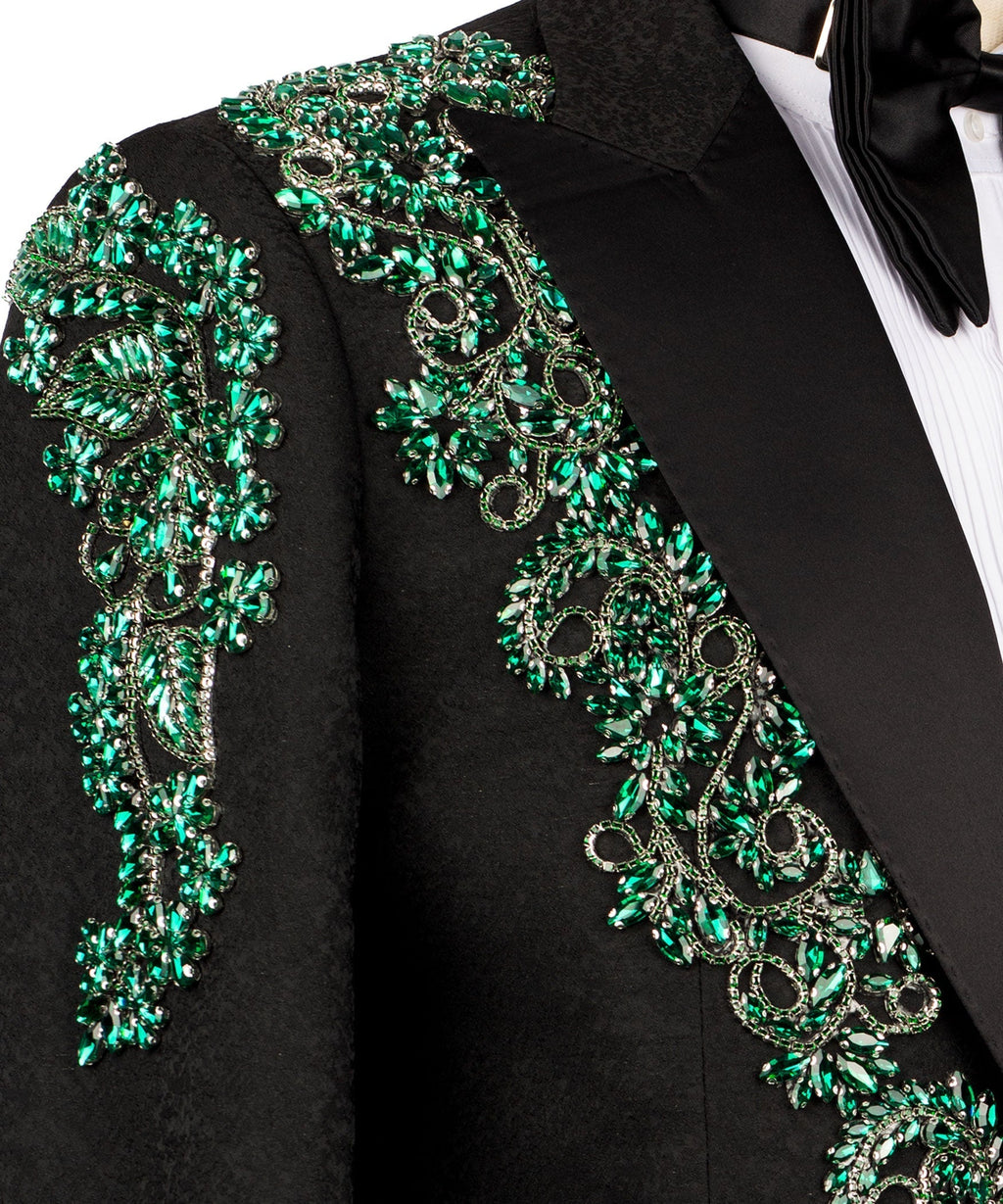 Close-up green stone-embroidered scrollwork on black tuxedo jacket
