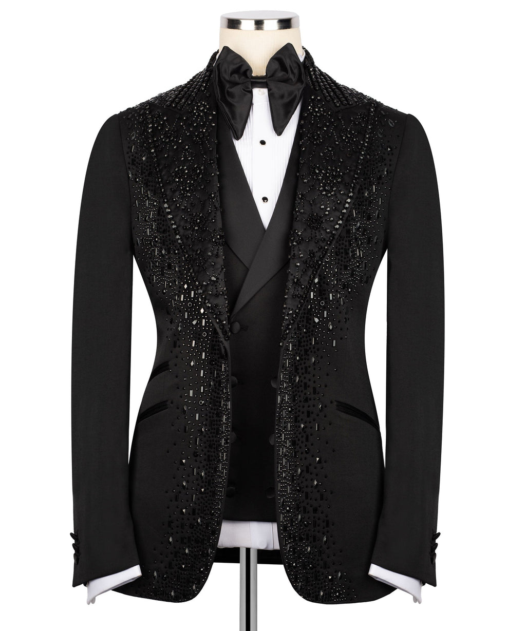 Black tuxedo jacket with stone embellishments, satin bow tie and white shirt